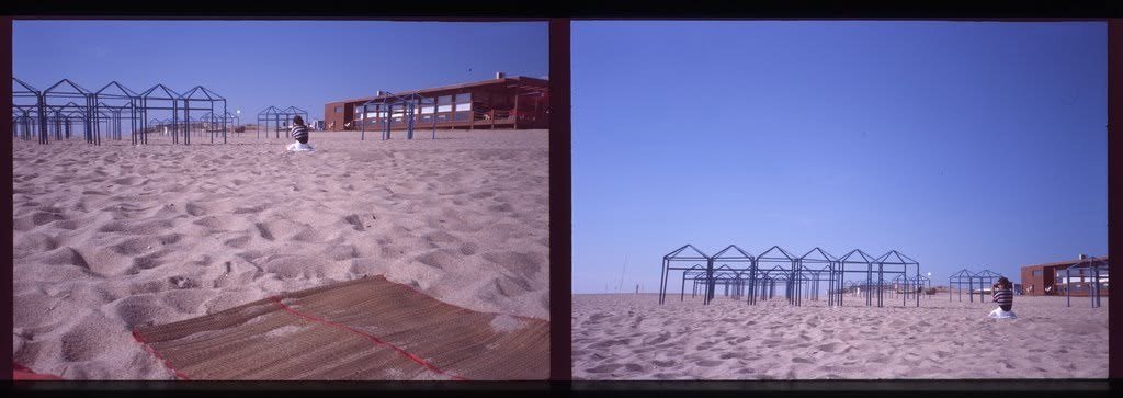 Empty beach shelters on pink sand, shown twice — once close, once from far off.