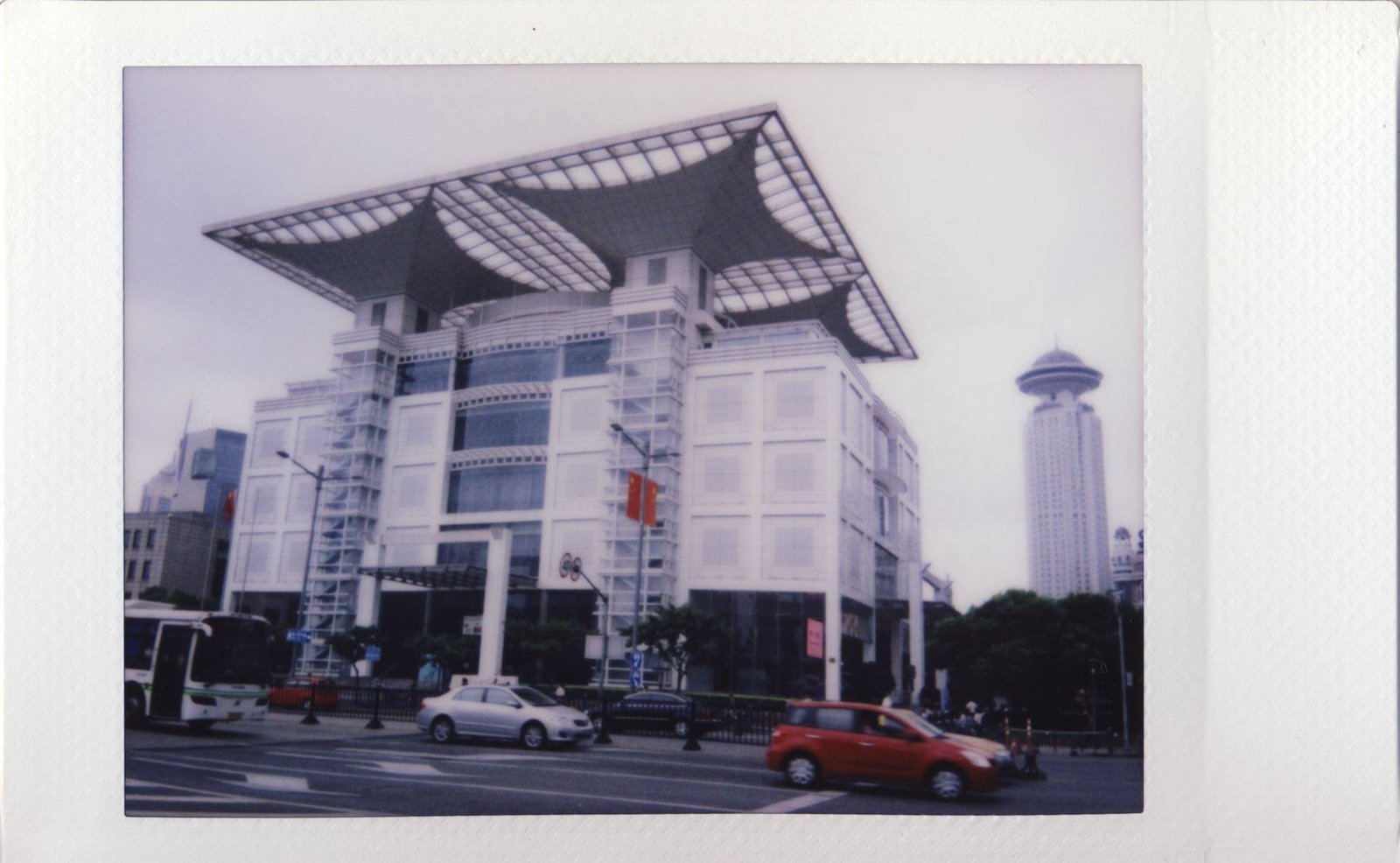 The Shanghai Urban Planning Exhibition Centre, traffic crossing in front of it.